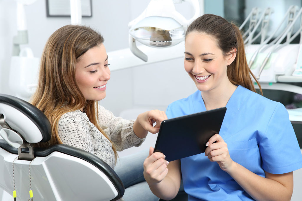 Dentist consulting patient