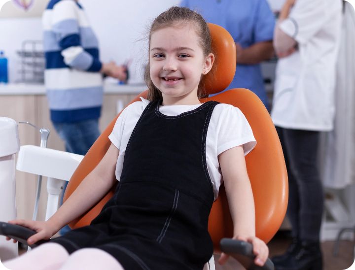 a small girl is smiling