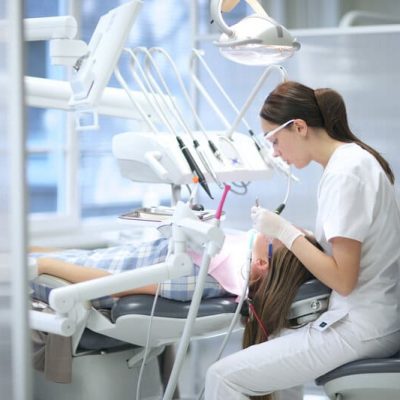 Dentist operating on patient: Emergency Dental Care in Townsville