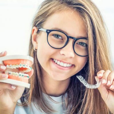 a girl comparing invisalign vs braces